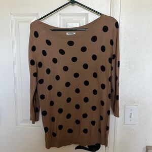 Brown sweater with black polka dots.